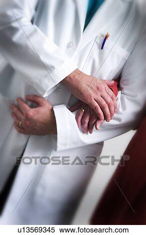 Medical staff helping senior to walk View Large Photo Image Stock Photography - Medical staff helping senior to walk. Fotosearch