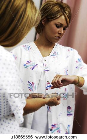 Nurse checking patients pulse View Large Photo Image Stock Photograph - Nurse checking patients pulse. Fotosearch