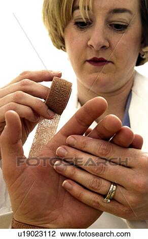 Therapist bandaging patients wrist View Large Photo Image Stock Image - Therapist bandaging patients wrist. Fotosearch