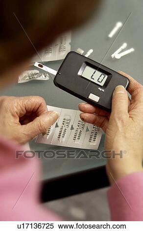 Woman checking blood sugar View Large Photo Image Stock Photography - Woman checking blood sugar. Fotosearch