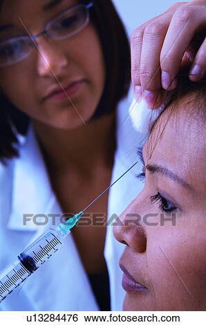 Woman getting botox View Large Photo Image Stock Photograph - Woman getting botox. Fotosearch