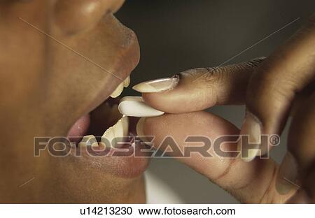 Woman taking a pill View Large Photo Image Stock Image - Woman taking a pill. Fotosearch
