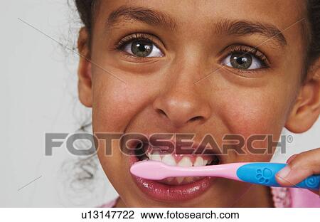Young African American girl brushing teeth View Large Photo Image Stock Image - Young African American girl brushing teeth. Fotosearch