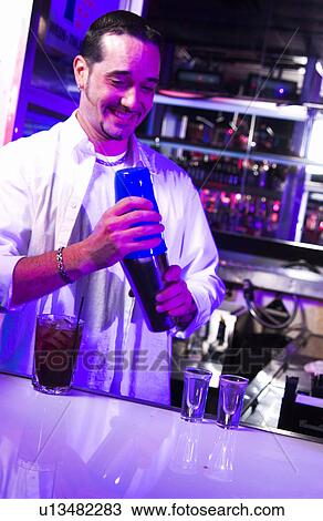Bartender mixing a shot at nightclub View Large Photo Image Stock Image - Bartender mixing a shot at nightclub. Fotosearch