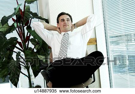Businessman leaning back in chair View Large Photo Image Stock Photography - Businessman leaning back in chair. Fotosearch