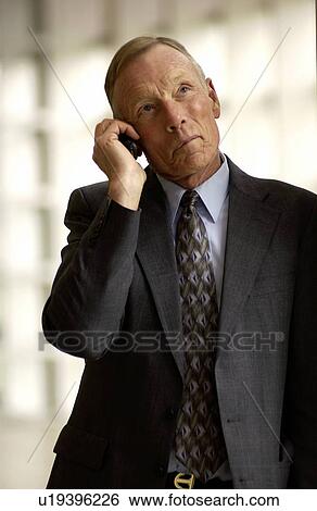 Stock Photograph - Businessman talking on cell phone. Fotosearch