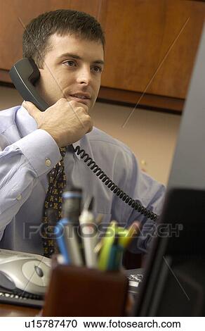 Stock Image - Businessman talking on phone. Fotosearch
