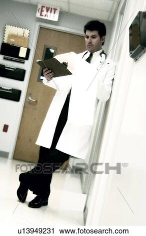 Stock Image - Doctor looking at patient chart. Fotosearch