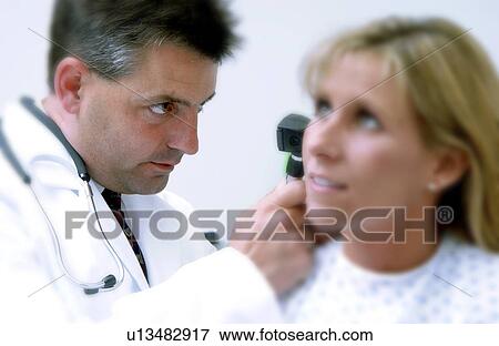 Physician examining patient View Large Photo Image Stock Photo - Physician examining patient. Fotosearch