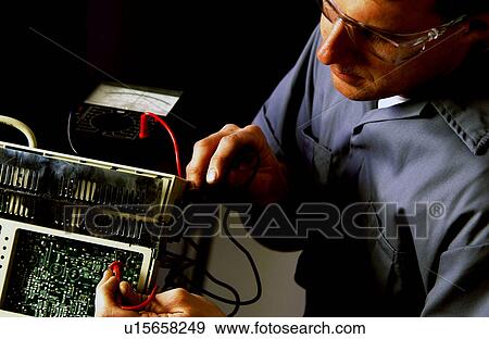 Technician repairing electronics item View Large Photo Image Stock Photo - Technician repairing electronics item. Fotosearch