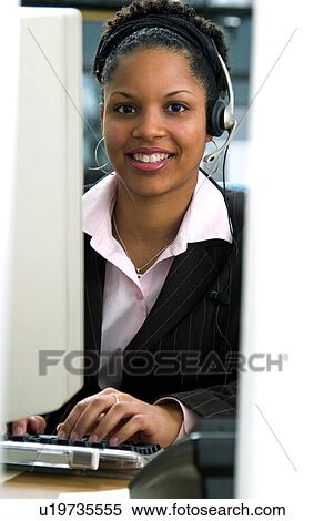 Stock Photography - African American woman at computer. Fotosearch