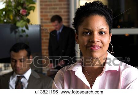 Businesswoman in office environment View Large Photo Image Stock Photograph - Businesswoman in office environment. Fotosearch
