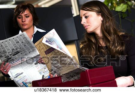 Businesswomen reading newspaper View Large Photo Image Stock Photo - Businesswomen reading newspaper. Fotosearch