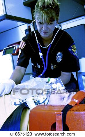 EMT in ambulance with patient View Large Photo Image Stock Image - EMT in ambulance with patient. Fotosearch
