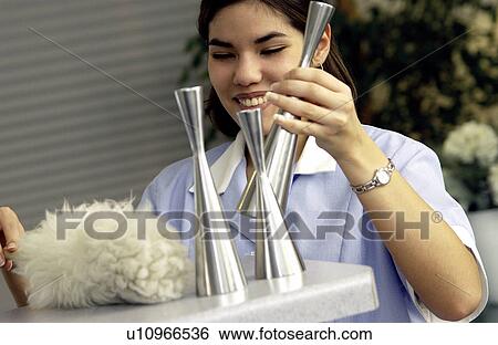 Stock Photograph - Hispanic woman cleaning. Fotosearch