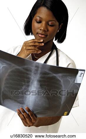Stock Image - Medical staff reading xrays. Fotosearch