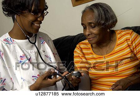 Stock Photography - Nurse checking patient s blood pressure. Fotosearch