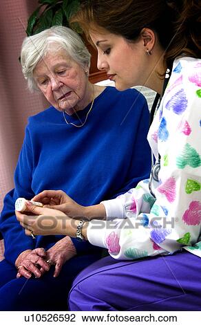 Nurse giving senior woman a bottle of pills View Large Photo Image Stock Image - Nurse giving senior woman a bottle of pills. Fotosearch
