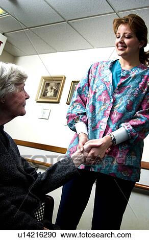 Nurse holding senior womans hand View Large Photo Image Stock Image - Nurse holding senior womans hand. Fotosearch