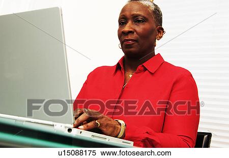 Older woman working on a laptop View Large Photo Image Stock Photography - Older woman working on a laptop. Fotosearch