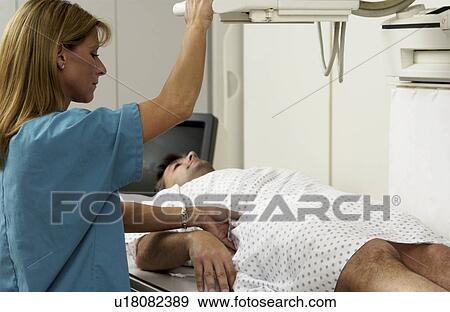 Patient having an xray taken View Large Photo Image Stock Photo - Patient having an xray taken. Fotosearch