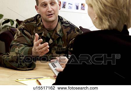 Stock Image - Reporter interviewing soldier. Fotosearch
