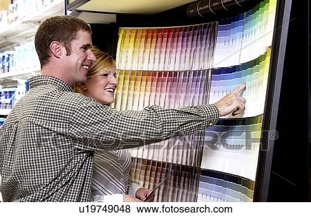 Couple looking at paint samples View Large Photo Image Stock Photo - Couple looking at paint samples. Fotosearch