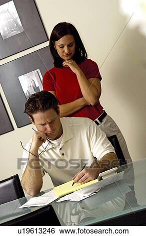 Couple looking over bills View Large Photo Image Stock Photograph - Couple looking over bills. Fotosearch