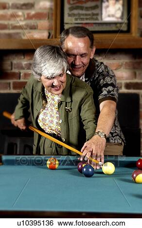 Stock Photograph - Couple playing pool. Fotosearch