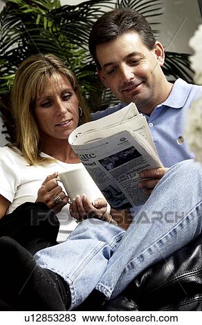 Stock Image - Couple reading the newspaper. Fotosearch