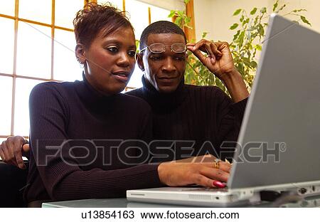 Couple working on laptop View Large Photo Image Stock Image - Couple working on laptop. Fotosearch