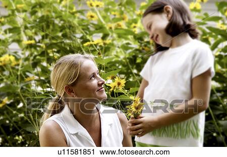 Daughter picking flowers for mother View Large Photo Image Stock Image - Daughter picking flowers for mother. Fotosearch