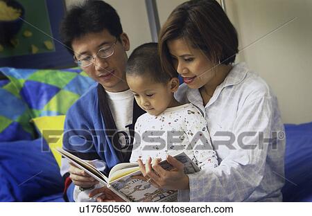 Parents reading to son View Large Photo Image Stock Image - Parents reading to son. Fotosearch