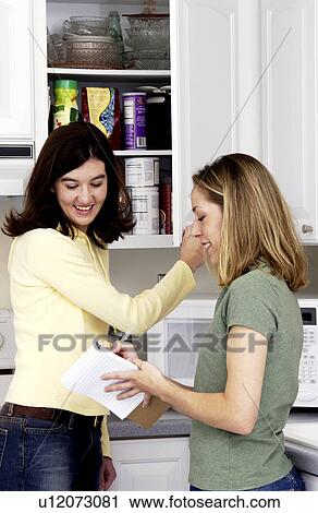 Stock Image - Two women creating a grocery list. Fotosearch