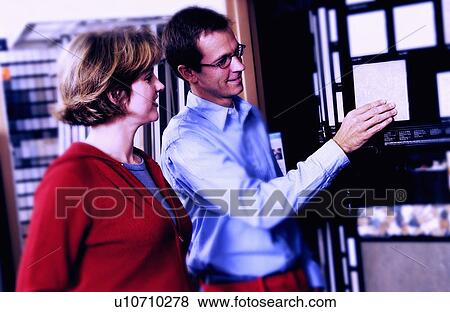 Woman looking at flooring samples View Large Photo Image Stock Photo - Woman looking at flooring samples. Fotosearch