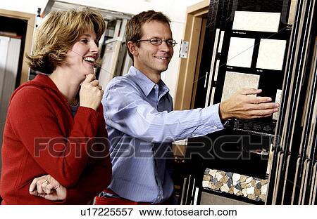 Woman looking at flooring samples View Large Photo Image Stock Photo - Woman looking at flooring samples. Fotosearch
