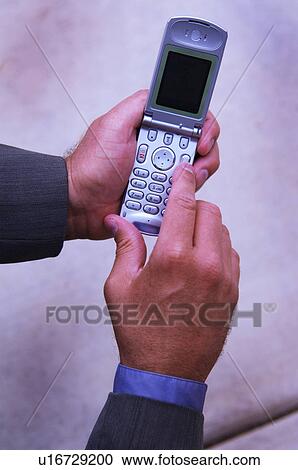Businessman dialing cell phone View Large Photo Image Stock Image - Businessman dialing cell phone. Fotosearch