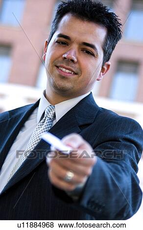 Businessman handing out business card View Large Photo Image Stock Photo - Businessman handing out business card. Fotosearch