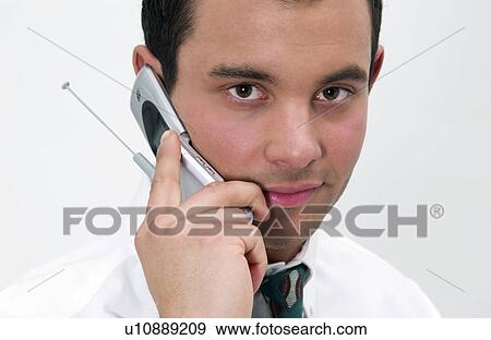 Stock Photo - Businessman on cell phone. Fotosearch