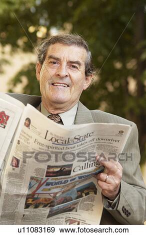 Businessman reading newspaper View Large Photo Image Stock Photo - Businessman reading newspaper. Fotosearch