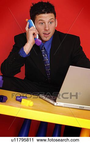 Stock Image - Businessman talking on phone. Fotosearch