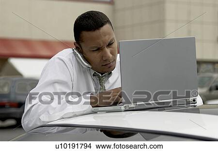 Businessman working on laptop View Large Photo Image Picture - Businessman working on laptop. Fotosearch