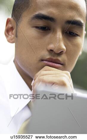 Stock Photo - Businessman working on laptop. Fotosearch