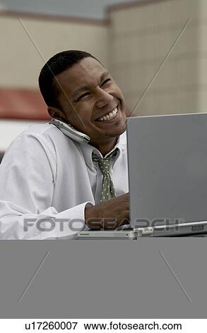 Stock Photo - Businessman working on laptop. Fotosearch