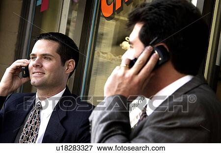 Stock Photo - Businessmen on cell phones. Fotosearch
