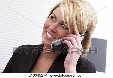 Businesswoman at desk talking on cordless phone View Large Photo Image Picture - Businesswoman at desk talking on cordless phone. Fotosearch