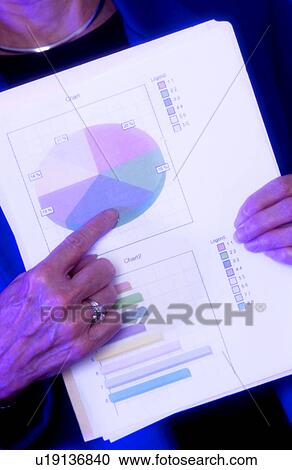 Stock Image - Businesswoman displaying pie chart. Fotosearch