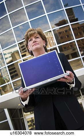 Stock Photo - Businesswoman holding laptop. Fotosearch