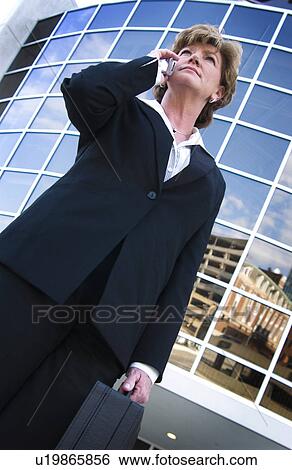 Stock Photograph - Businesswoman on cell phone. Fotosearch