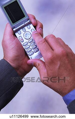 Stock Photo - Businessman dialing cell phone. Fotosearch